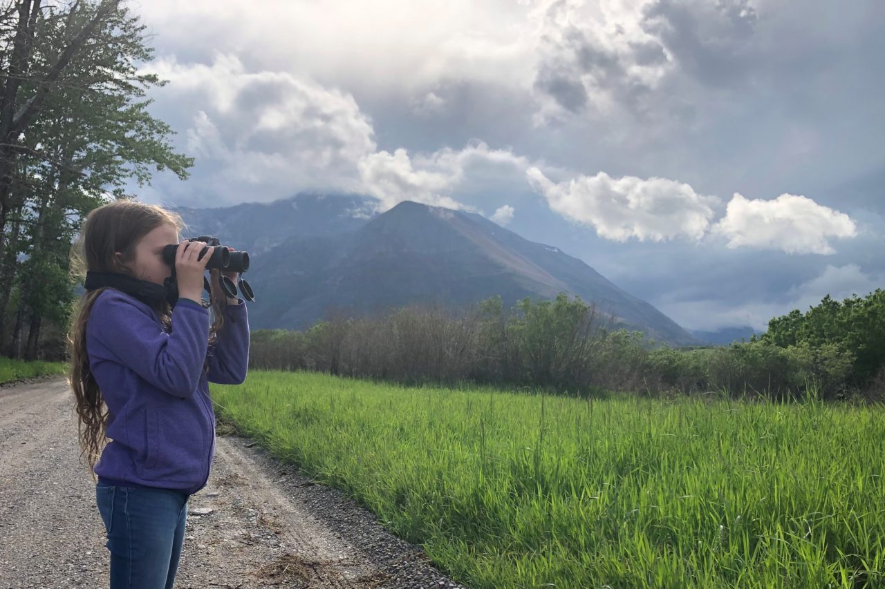 A girl birding at Waterton Lakes National Park, Alberta, Canada