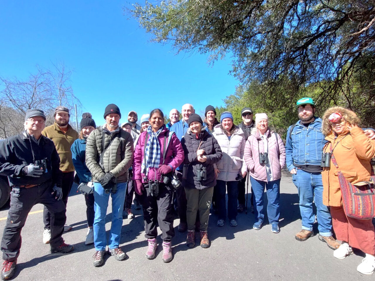 A group of birdwatchers faces the camera.