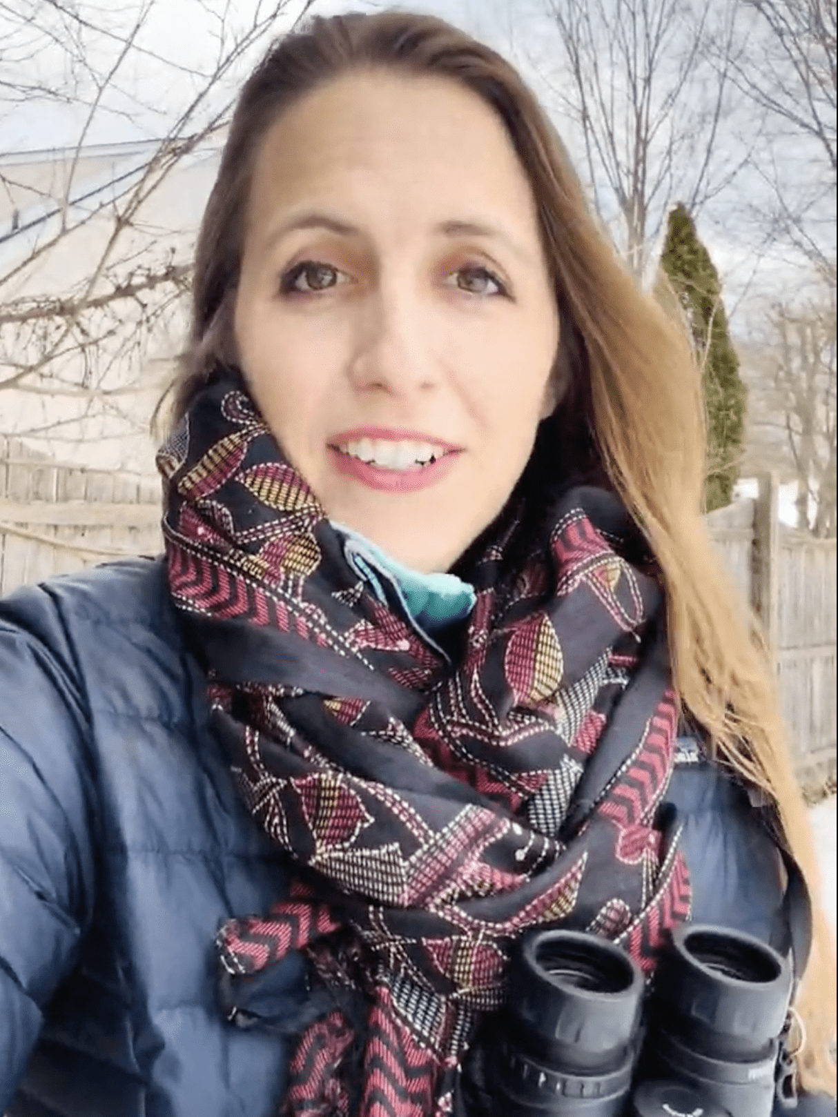 Woman looking right at you with binoculars.