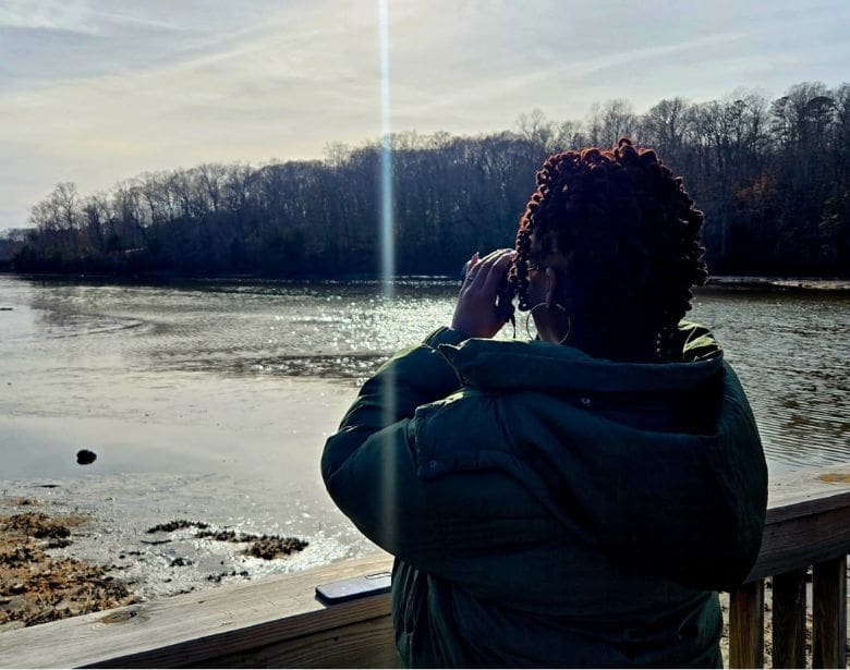 A person using binoculars to birdwatch.