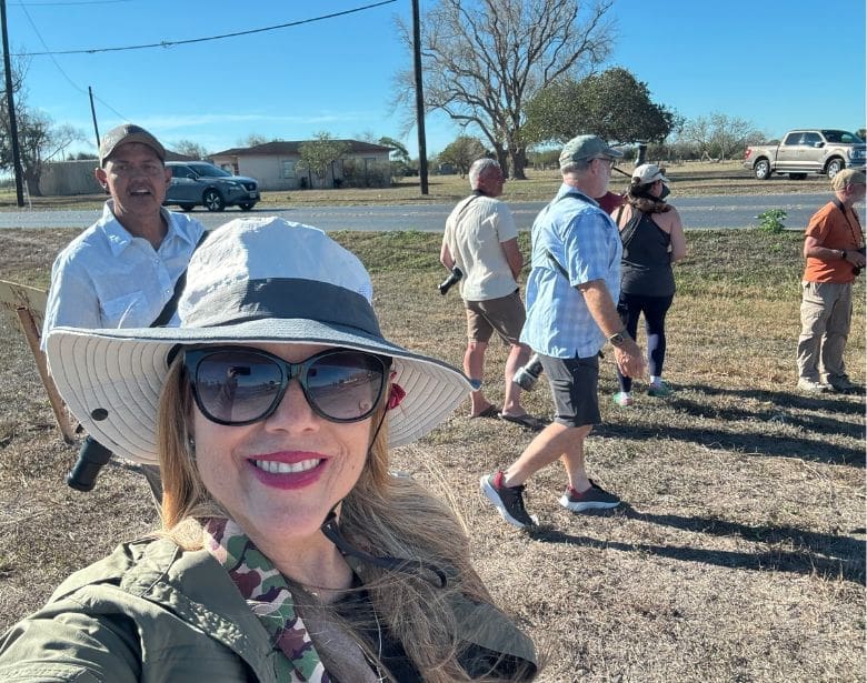 Group of people smiling and birdwatching.