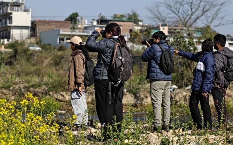 Group of people birdwatching.