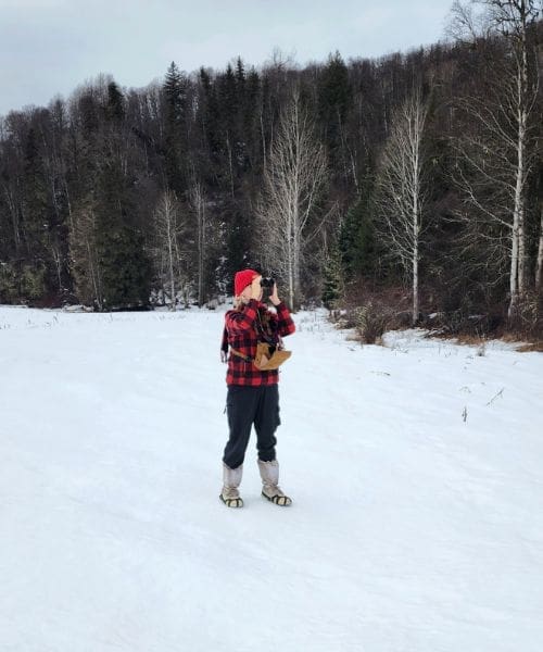A person using binoculars to birdwatch.