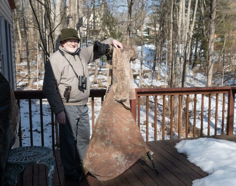 A person with binoculars smiling.
