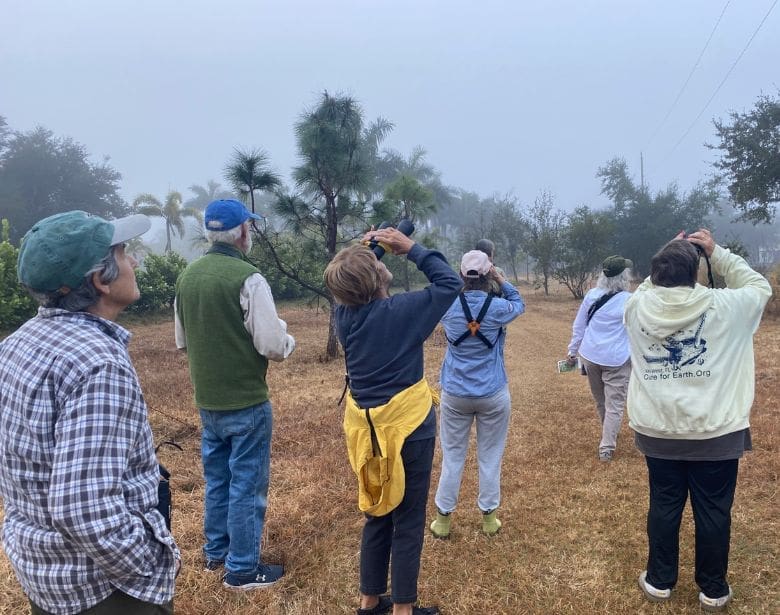 Group of people birdwatching.