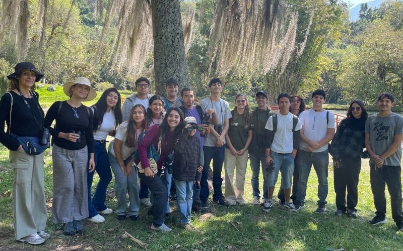 Group of smiling people with binoculars.