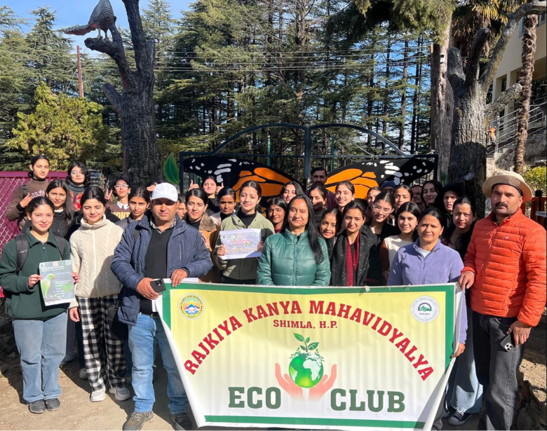 Large group of smiling people with a poster reading "Rajkiya Kanya Mahavidyalya Eco Club".