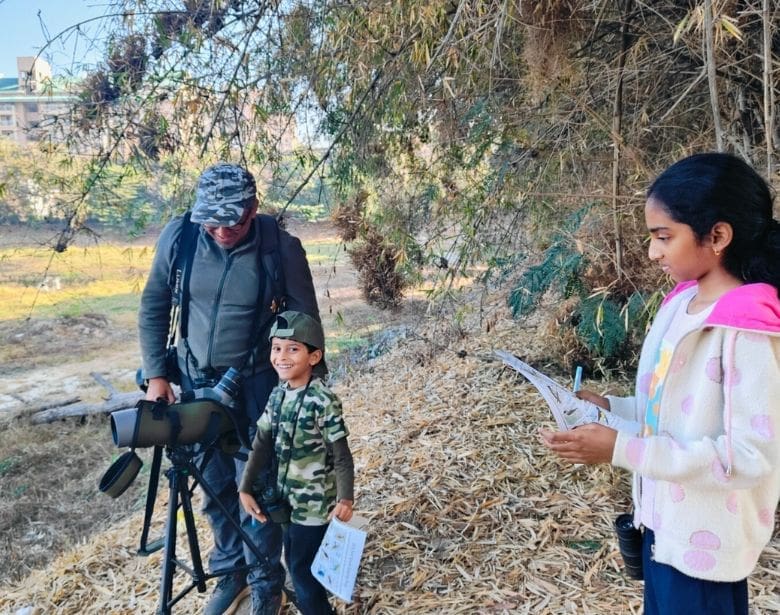 Group of people birdwatching.
