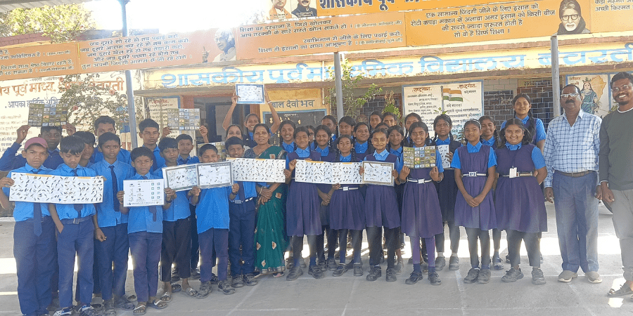 Group of smiling children and adults with posters of birds.