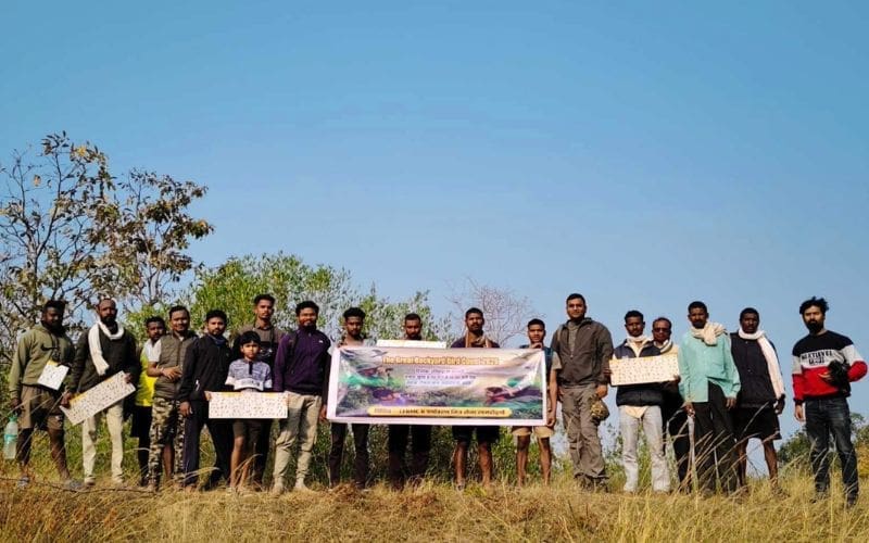 Group of smiling people holding a sign about the Great Backyard Bird Count.