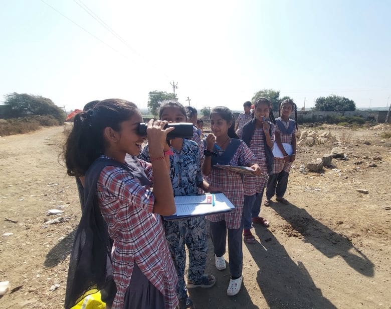 A group of people birdwatching.
