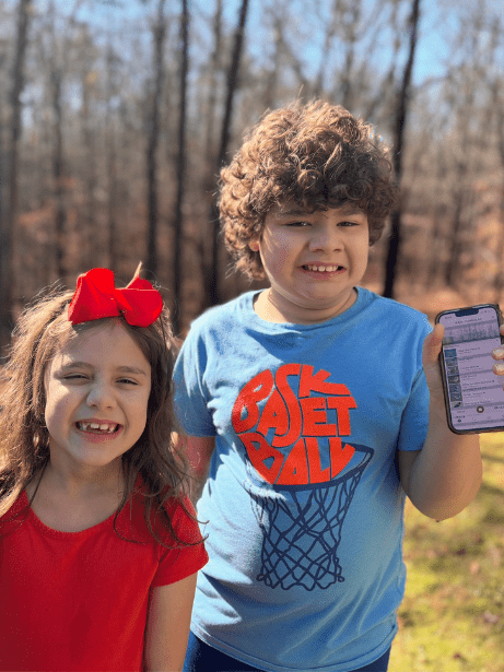 Two smiling children using the Merlin Bird ID app.