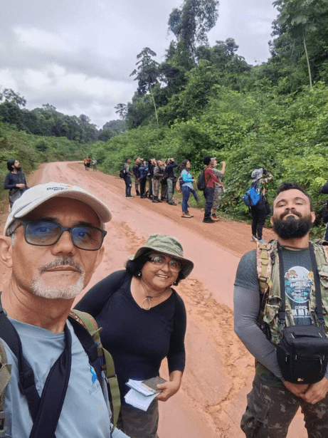 A group of people birdwatching.