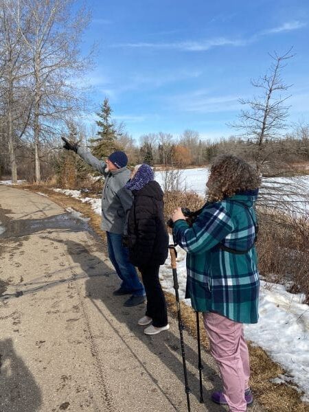 A group of people birdwatching.