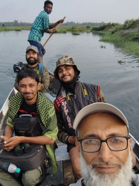 Group of people smiling while on a boat.